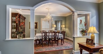 formal dining room with arched opening chandelier and wood furniture in charlotte nc whole home remodel