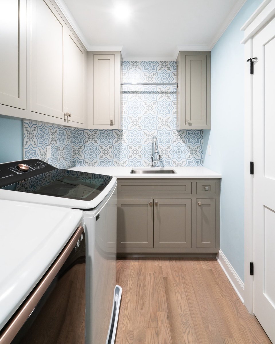 custom laundry room with patterned blue tile gray cabinetry utility sink and washer in charlotte nc