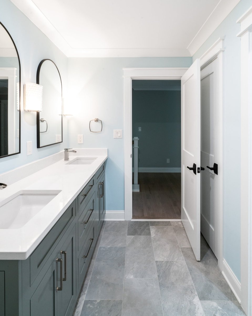 double sink bathroom with gray vanity blue walls and large format tile floor in a custom home in charlotte nc