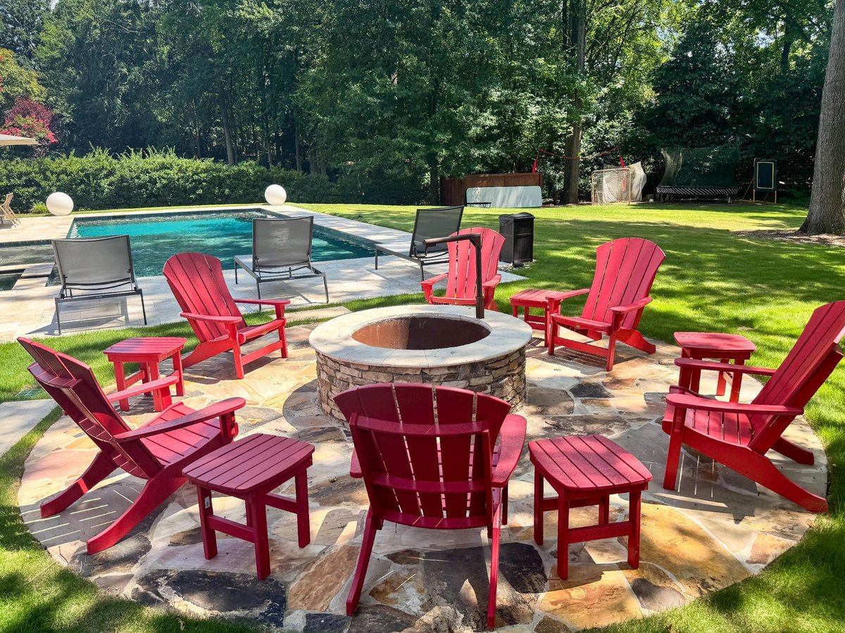 charlotte nc home project backyard fire pit with red adirondack chairs beside swimming pool