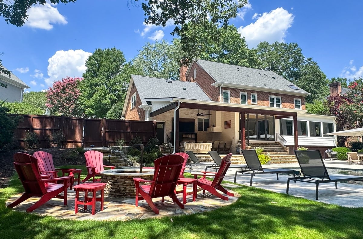 charlotte nc home project backyard with stone fire pit red adirondack chairs covered porch and pool