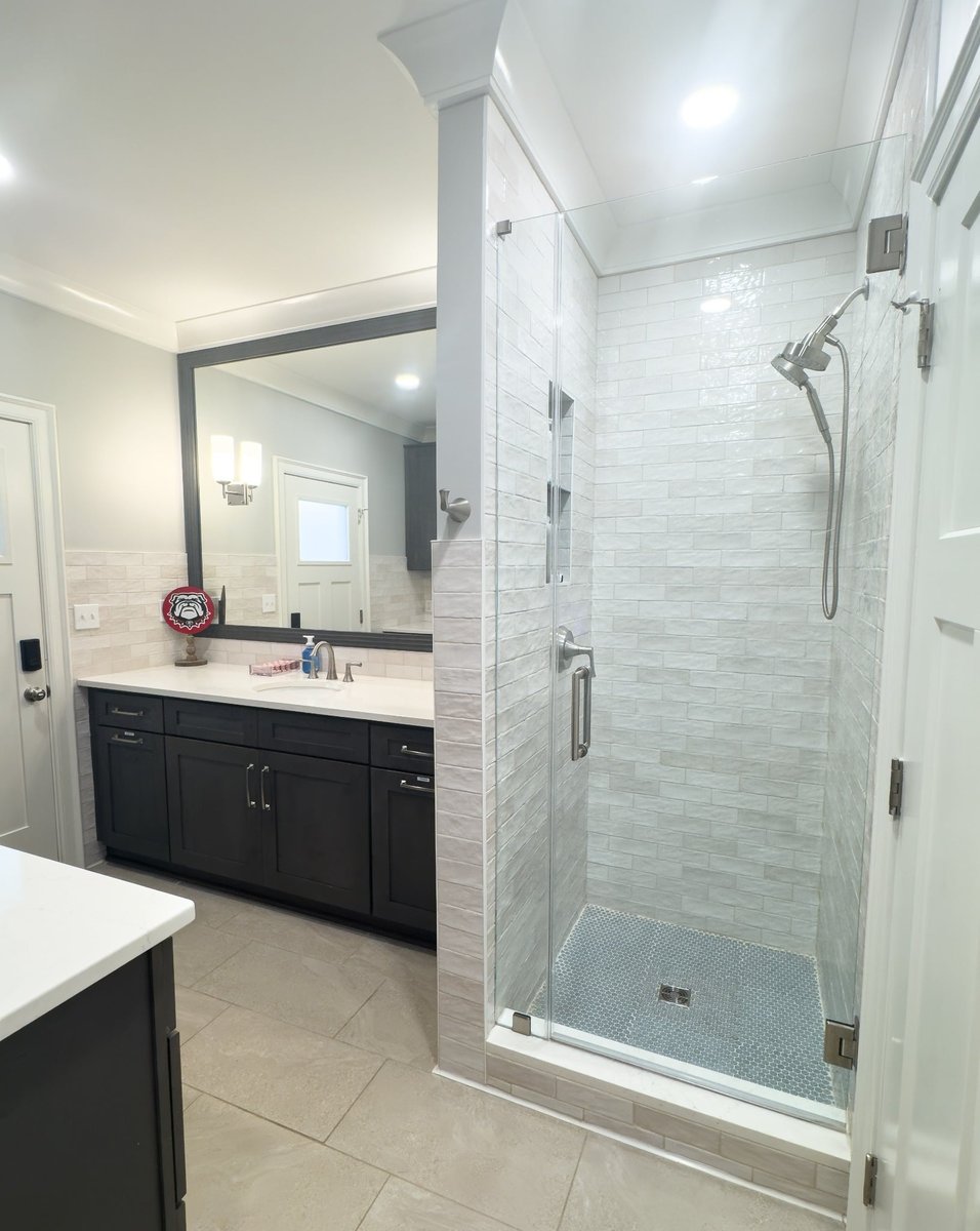 charlotte nc home project bathroom with dark vanity white countertop and glass walk in shower