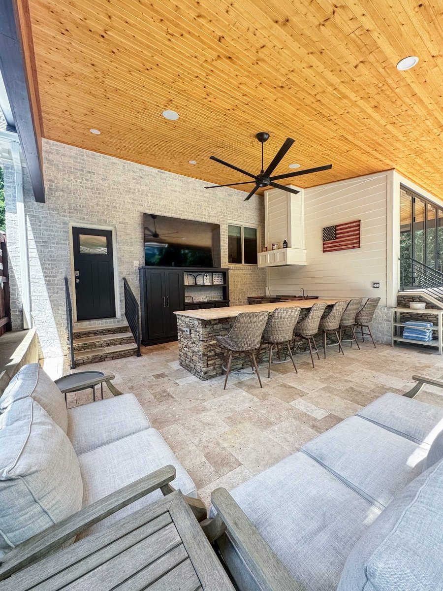 charlotte nc home project covered patio with outdoor kitchen stone bar wicker stools and lounge seating