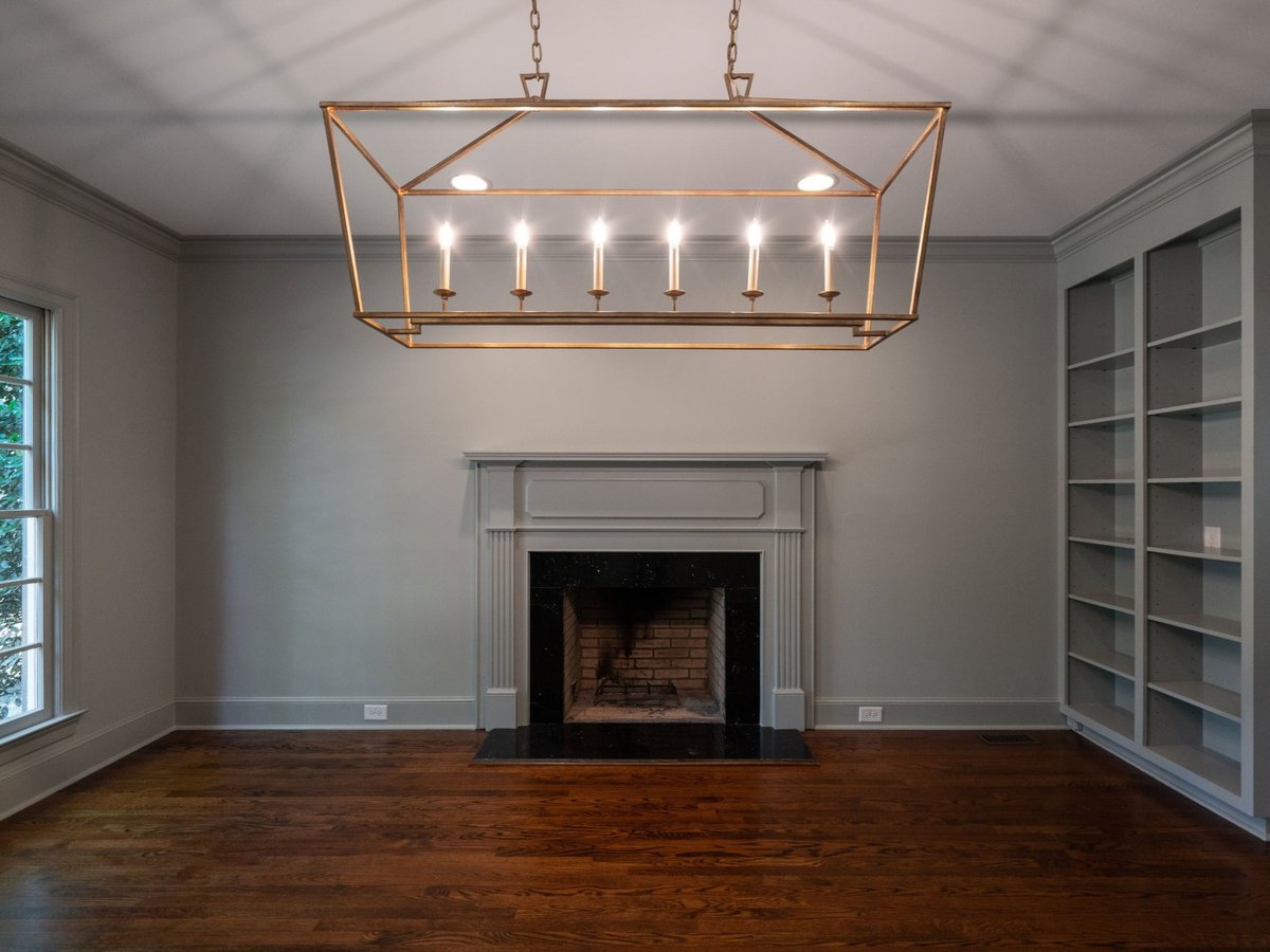charlotte nc home project front view of dining room fireplace hardwood floors and brass linear chandelier