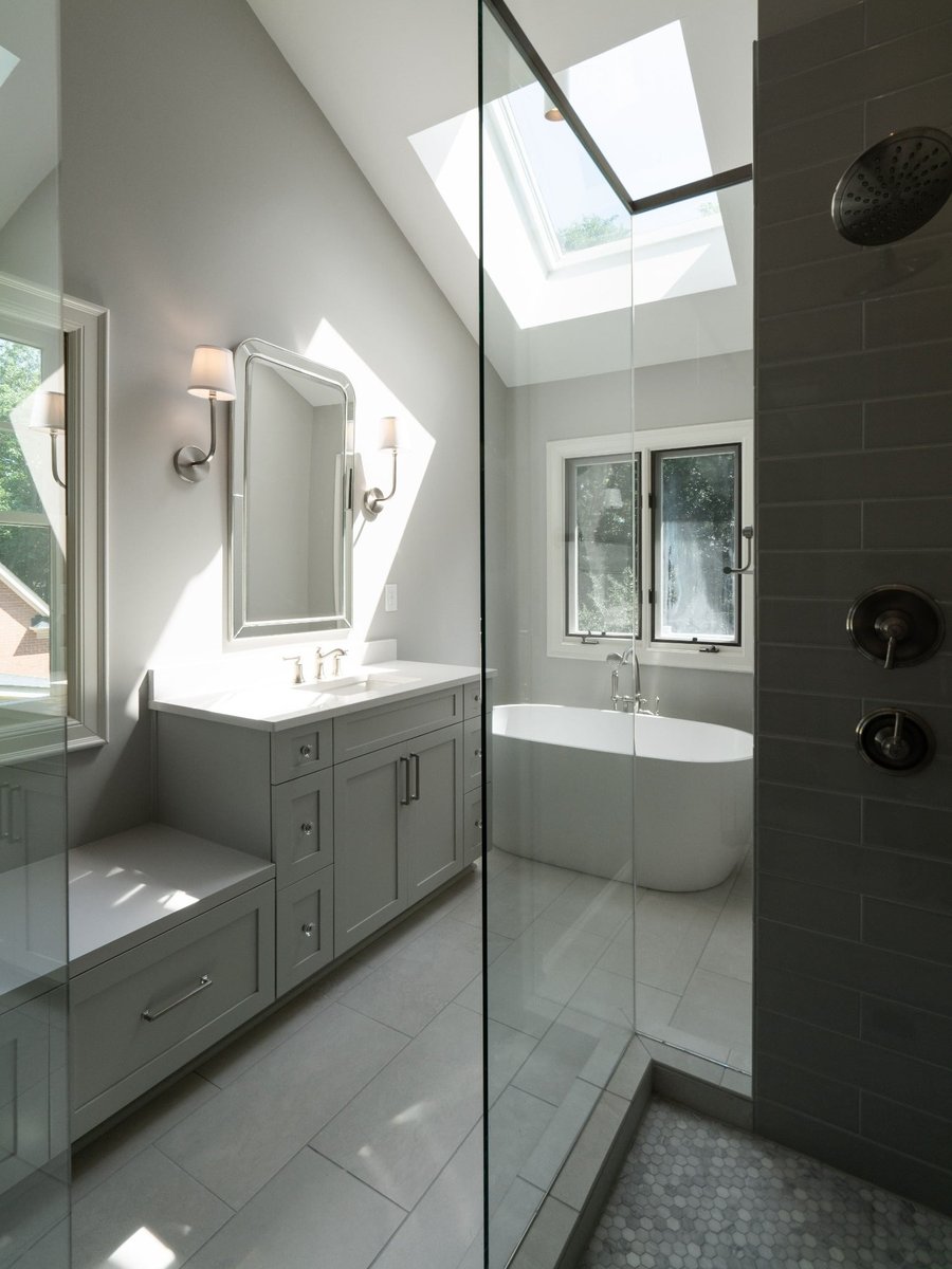 charlotte nc home project primary bathroom with skylight freestanding tub and glass enclosed tile shower