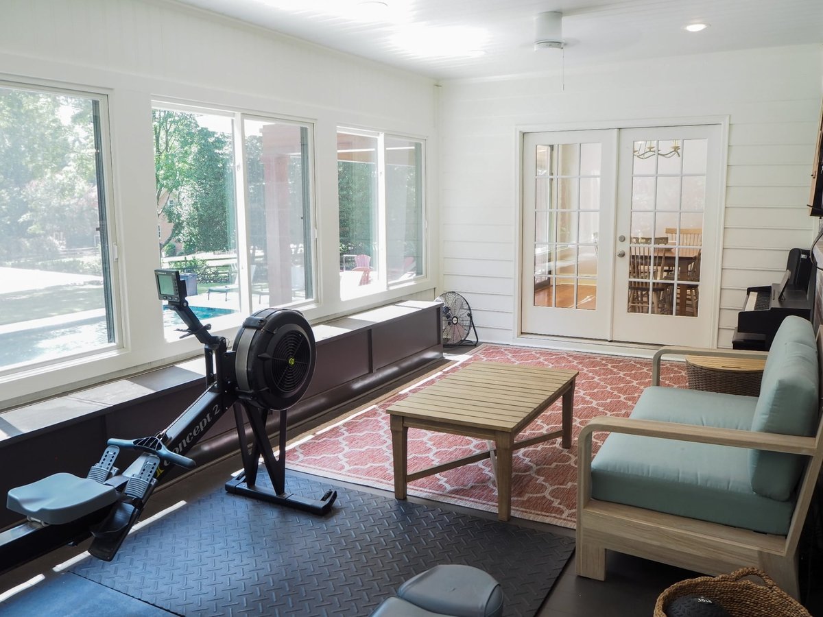 charlotte nc home project sunlit four season room with rowing machine sofa coffee table and french doors
