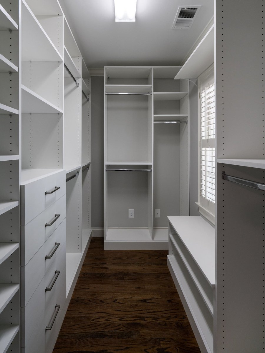 charlotte nc home project walk in closet with white custom shelving drawers hanging rods and hardwood floor