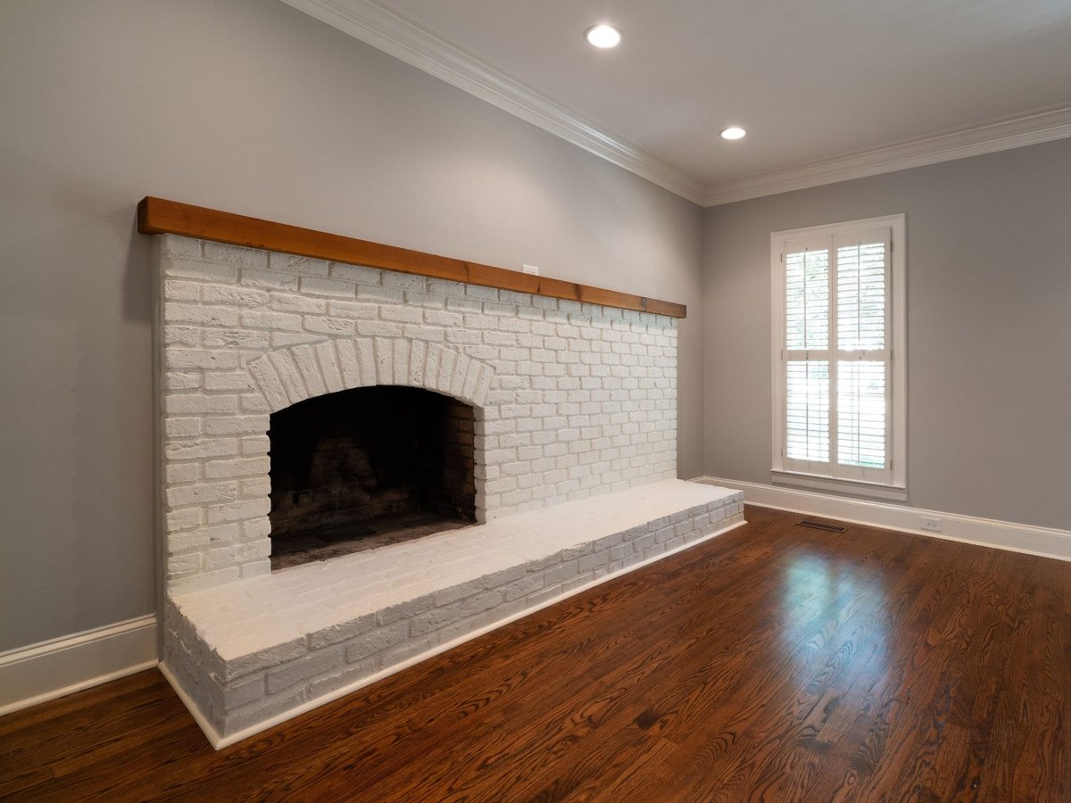 charlotte nc home project white brick fireplace with wood mantel and hardwood floors