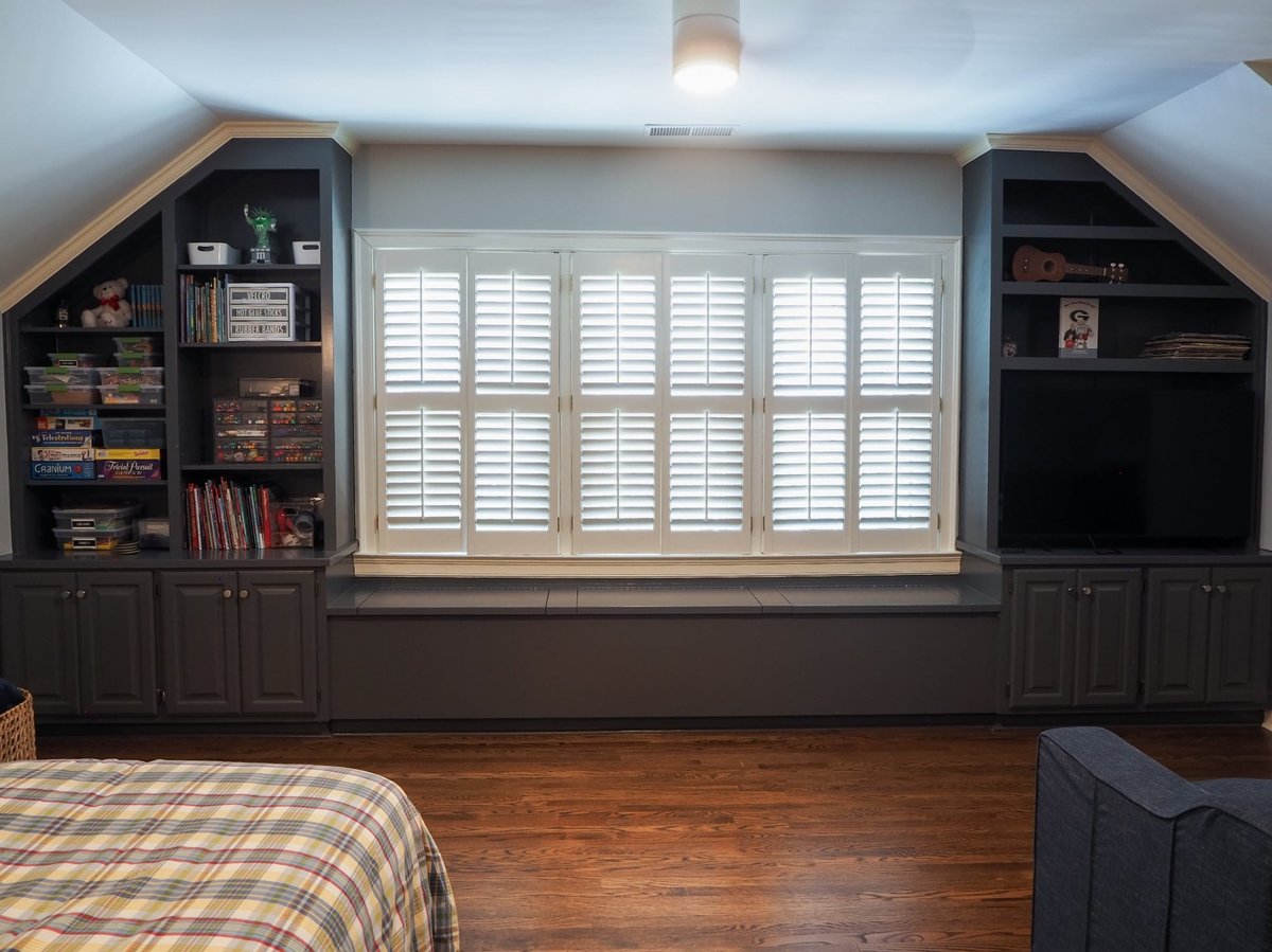 custom bonus room built ins framing a shuttered window in charlotte nc home project