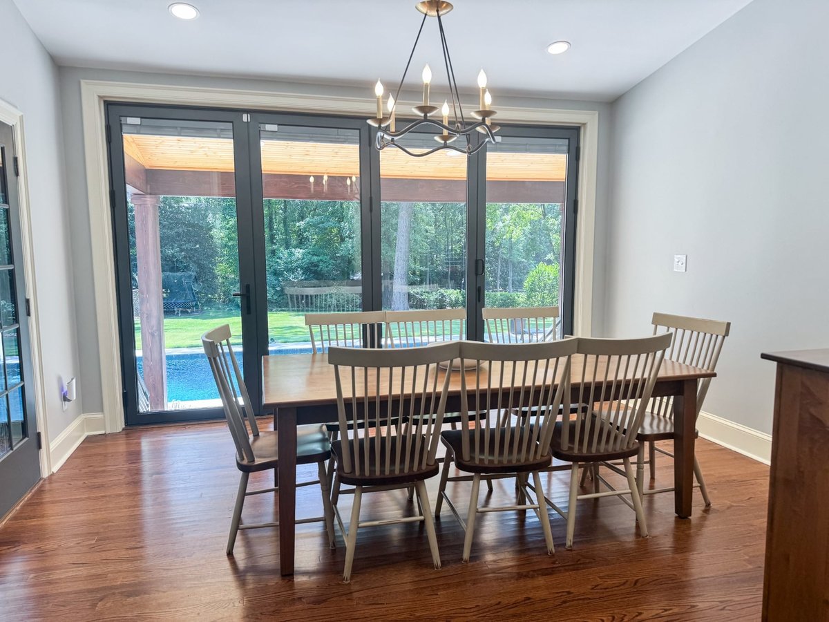 open folding glass doors connect breakfast nook to backyard pool in charlotte nc home project