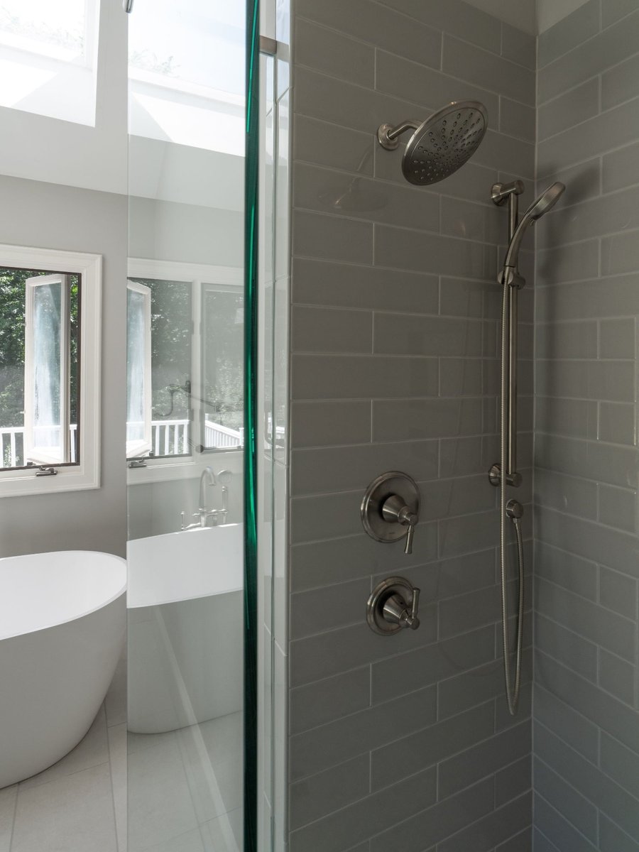 walk in glass shower with gray subway tile rain shower and handheld fixture in charlotte nc home project