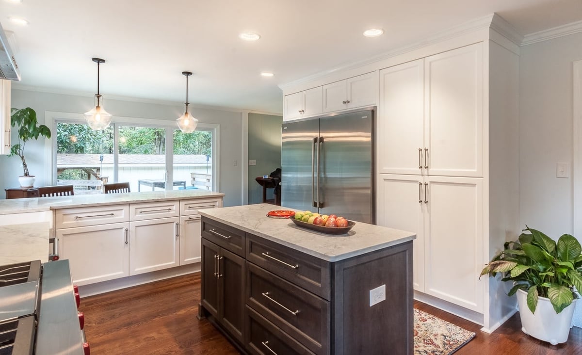 kitchen remodel with dark wood island white cabinetry stainless steel refrigerator and quartz countertops in charlotte nc