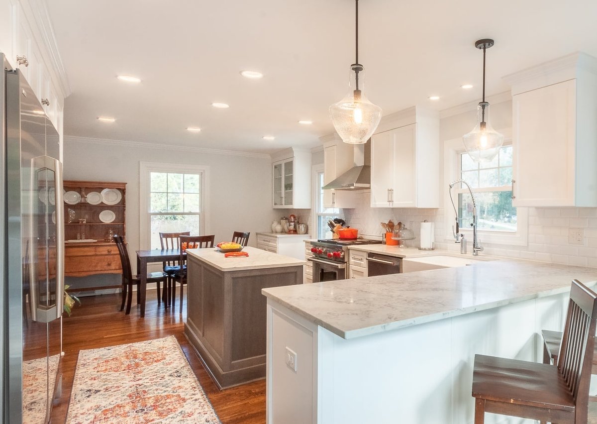 kitchen remodel with white cabinetry quartz counters center island and pendant lighting in charlotte nc