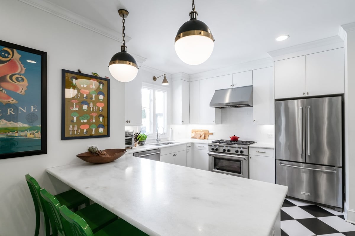 charlotte nc kitchen remodel featuring marble island white cabinets stainless steel range and refrigerator
