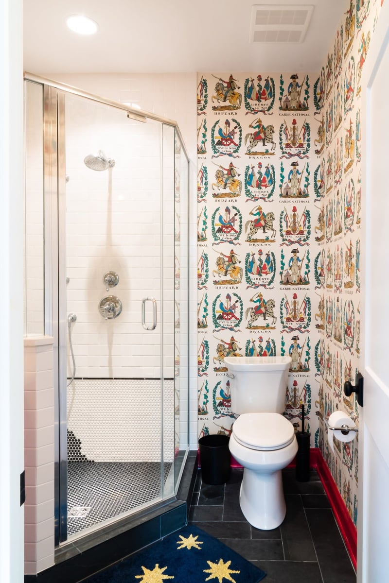 custom home bathroom with glass shower colorful wallpaper red trim and black tile in charlotte nc