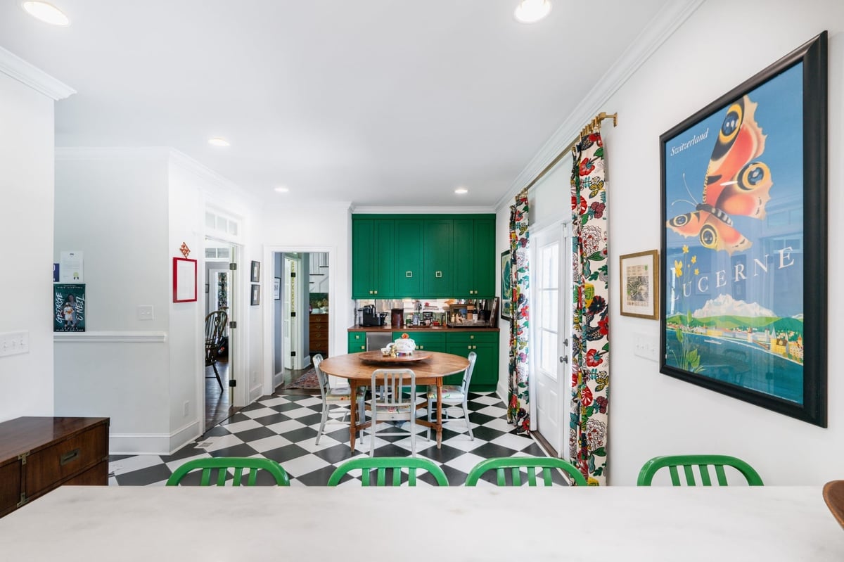 custom home dining area with green built in cabinetry wood table floral curtains and checkerboard floor in charlotte nc
