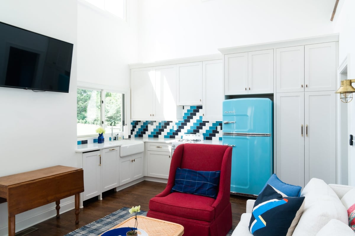 custom home guest house kitchen with turquoise retro refrigerator and white cabinets in charlotte nc