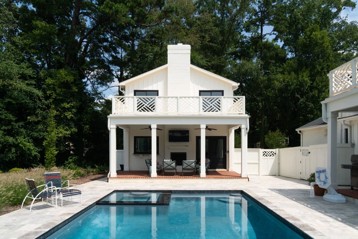 custom home pool with white guest house balcony and covered outdoor living area in charlotte nc