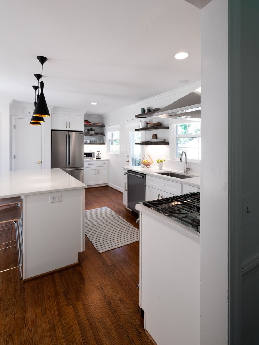 kitchen remodel with white cabinets stainless appliances open wood shelving and hardwood floors in charlotte nc