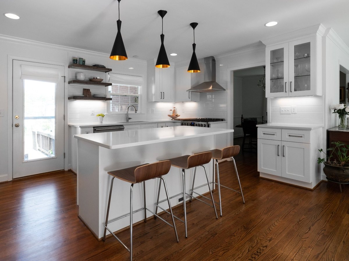 kitchen remodel with white island black pendant lights white cabinets and hardwood floors in charlotte nc