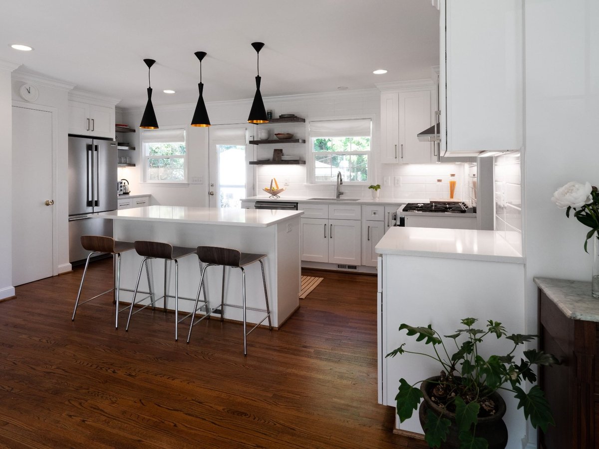 kitchen remodel with white island stainless appliances open shelving and hardwood floors in charlotte nc