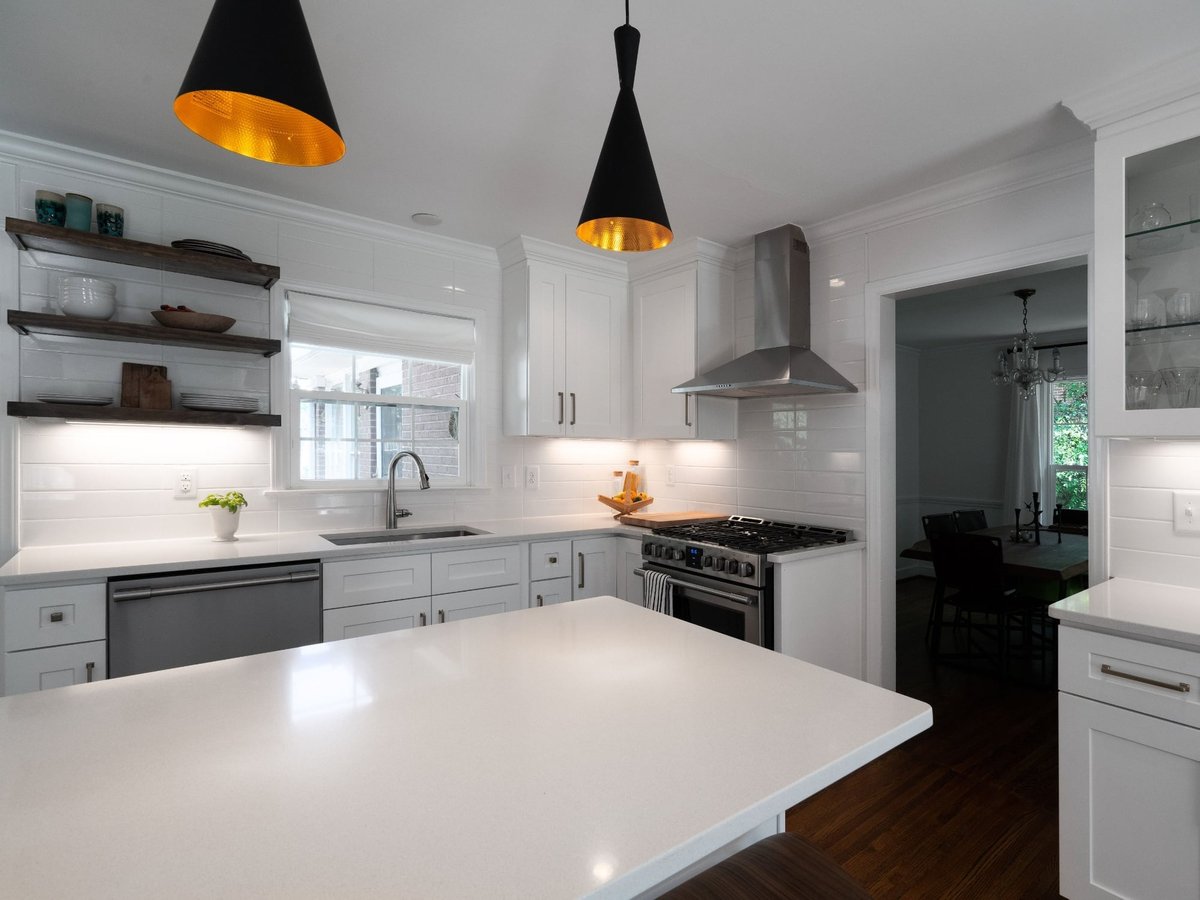 kitchen remodel with white quartz island open wood shelves stainless range and black pendant lights in charlotte nc