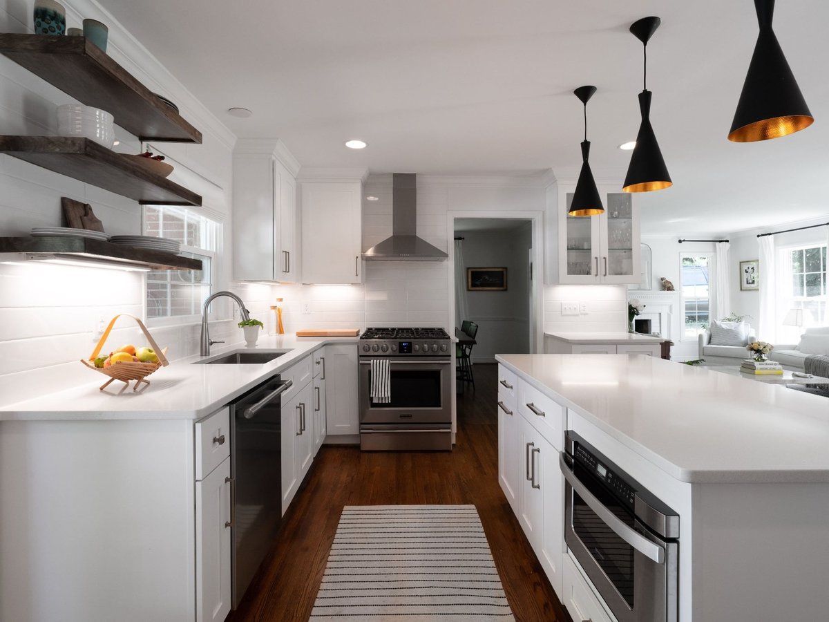kitchen remodel with white quartz island stainless range open wood shelving and adjoining living room in charlotte nc