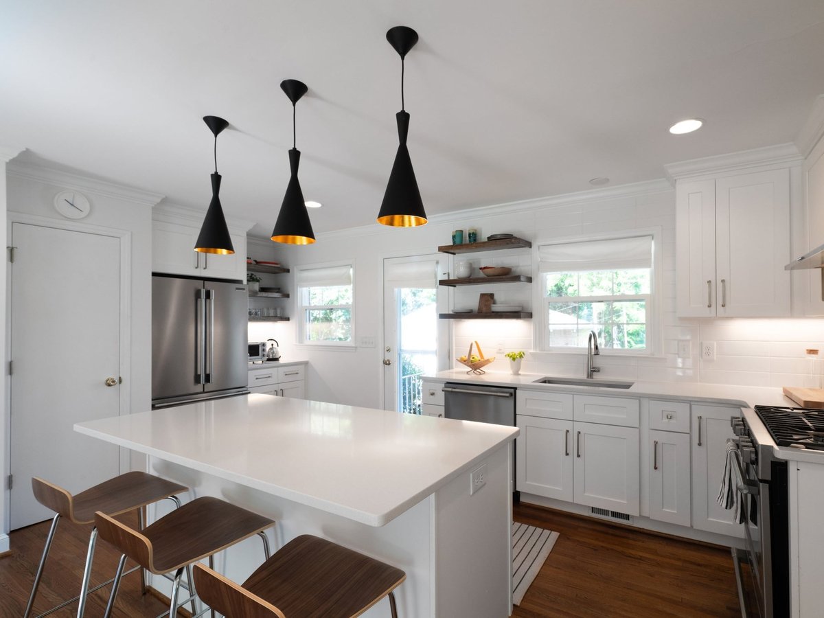 kitchen remodel with white quartz island stainless refrigerator open shelving and black pendant lights in charlotte nc