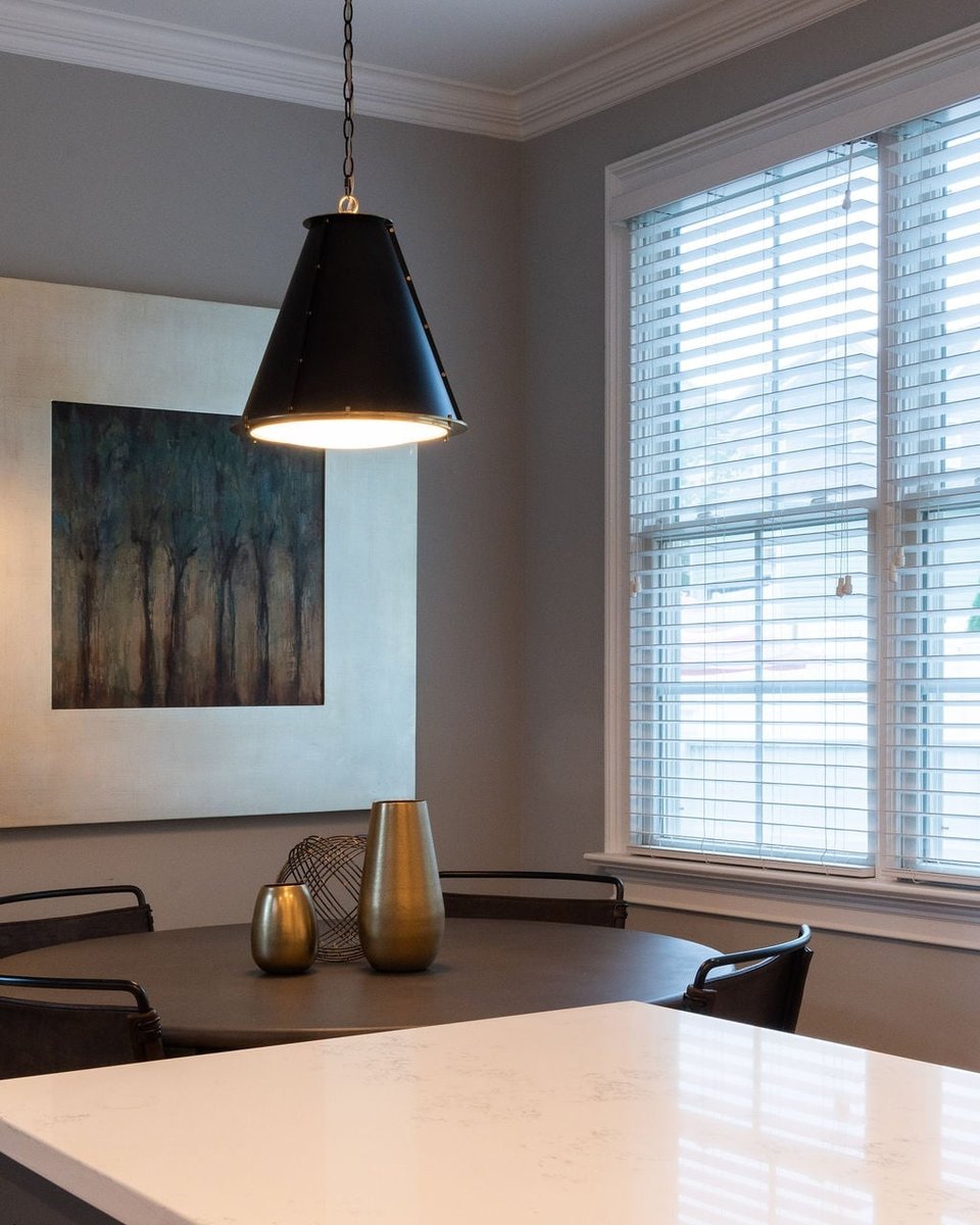 breakfast nook with black pendant light round table and wall art in a first floor remodel in fort mill sc