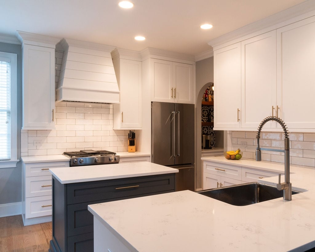 first floor remodel kitchen with white shaker cabinets dark island subway tile and stainless appliances in fort mill sc