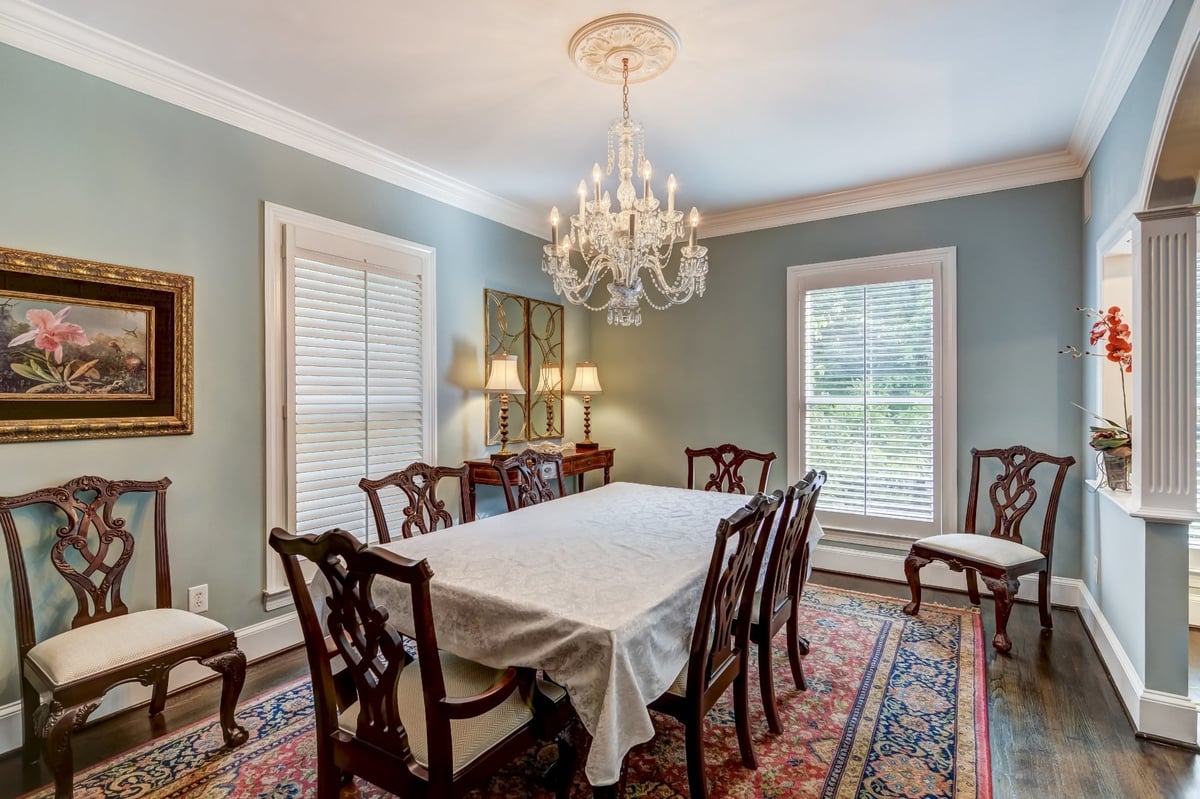 formal dining room with crystal chandelier wood chairs and blue gray walls in charlotte nc whole home remodel