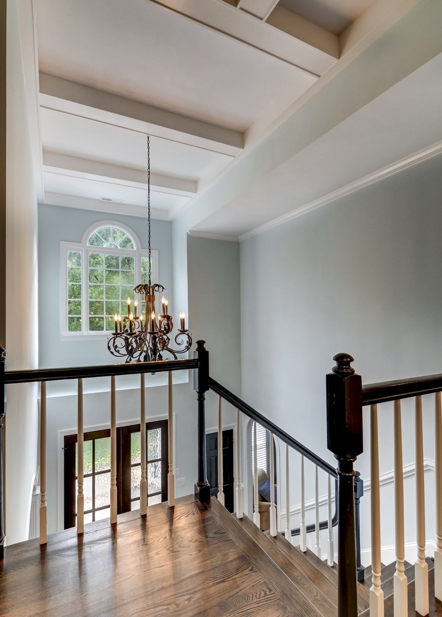 two story foyer with chandelier and wood railing in charlotte nc whole home remodel