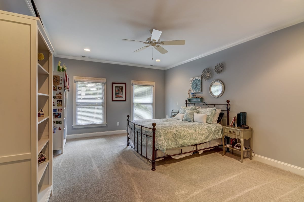 spacious bedroom with iron bed and built in shelving in charlotte nc whole home remodel