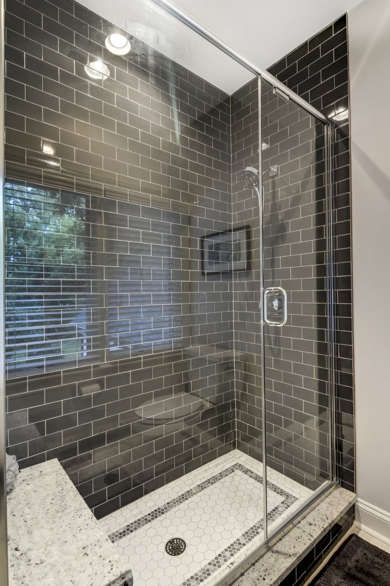 tiled shower with glass enclosure and hexagon floor in charlotte nc whole home remodel