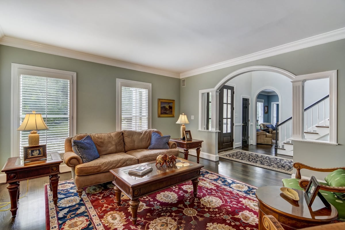 traditional living room with tan sofa green armchairs and foyer view in charlotte nc whole home remodel