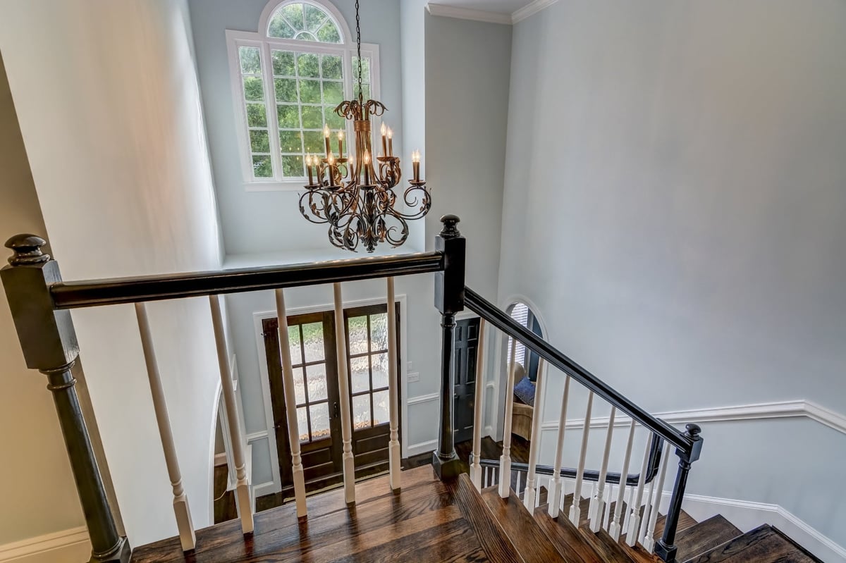 two story stairwell with coffered ceiling and large arched window in charlotte nc whole home remodel