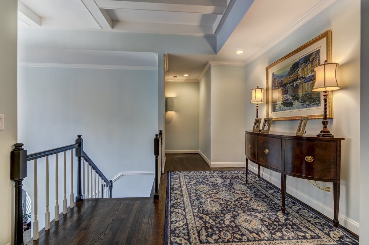 upstairs hallway with coffered ceiling console table and area rug in charlotte nc whole home remodel