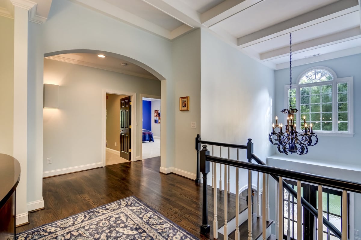 upstairs landing with dark hardwood floors and chandelier in charlotte nc whole home remodel