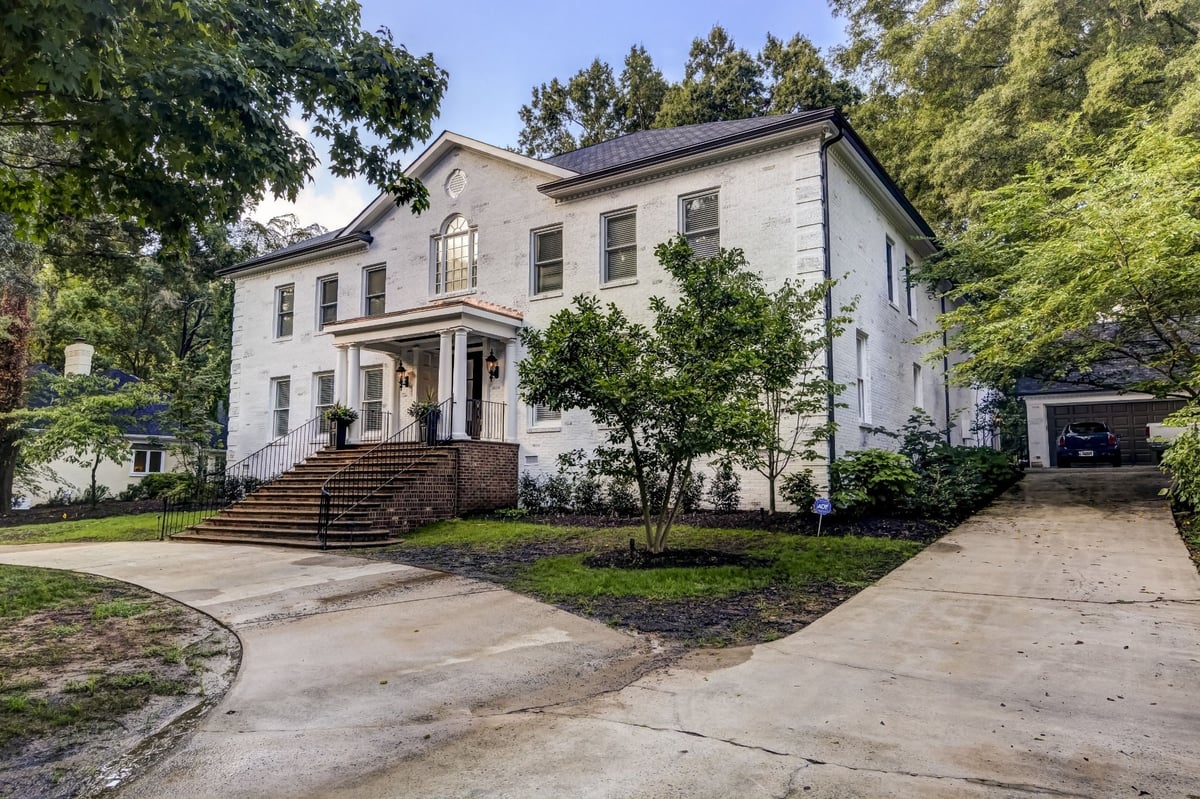 white brick home front exterior with brick steps and side driveway in charlotte nc whole home remodel