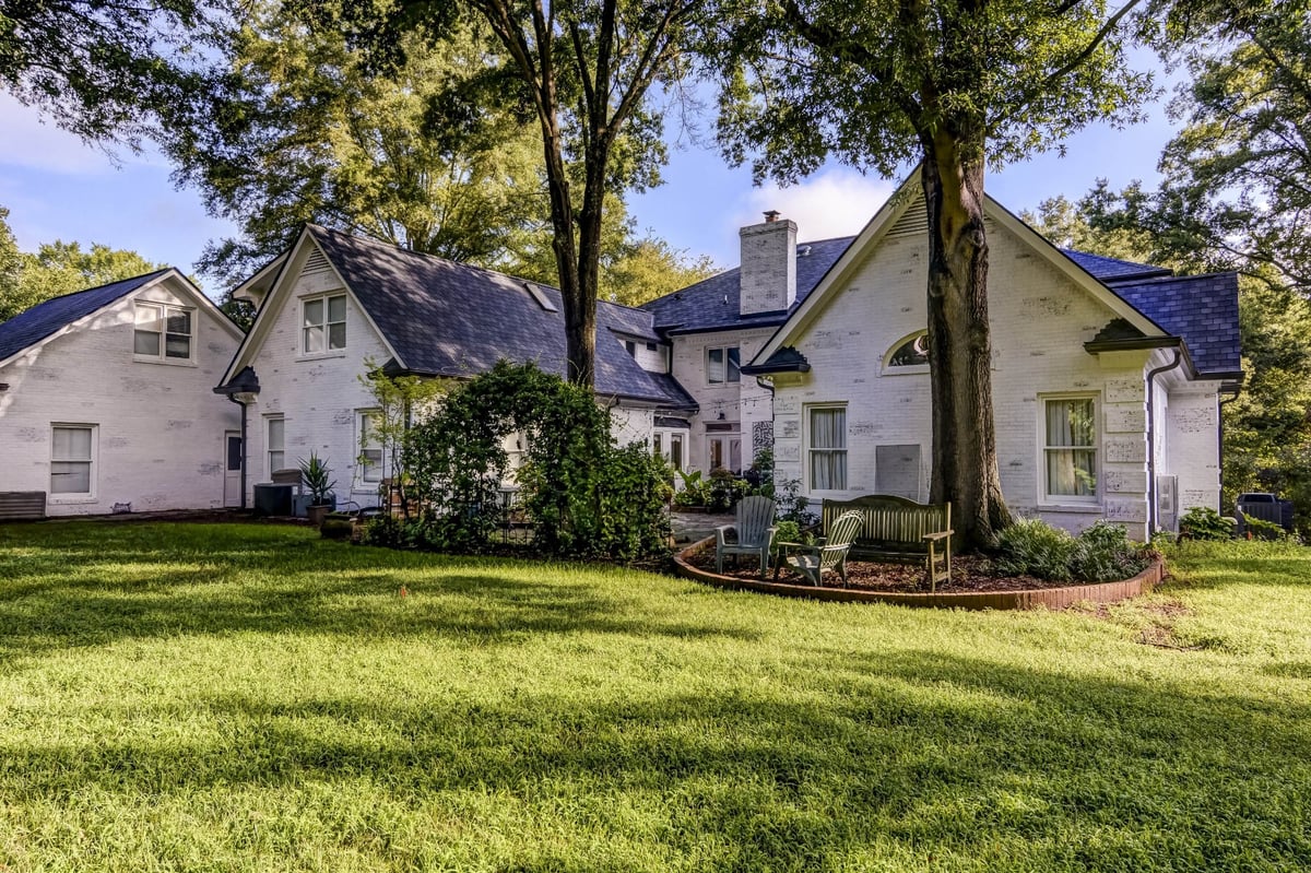 white brick rear exterior with gabled wings and shaded backyard in charlotte nc whole home remodel