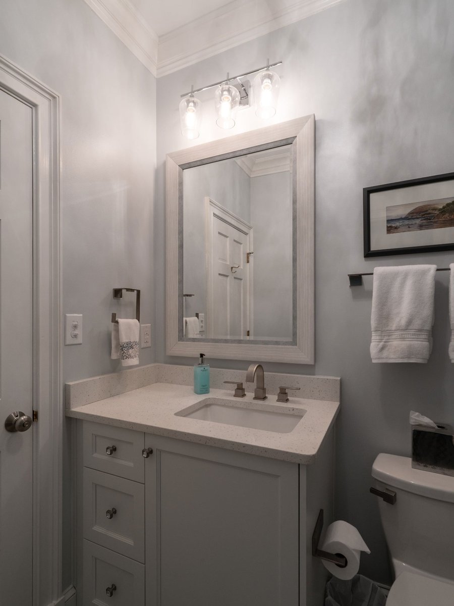 first floor remodel white bathroom vanity and framed mirror in charlotte nc