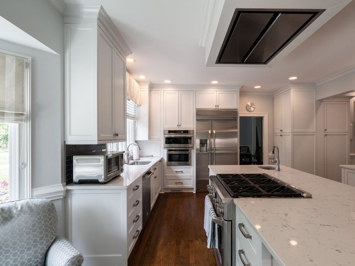 galley view of white kitchen and island in charlotte nc first floor remodel