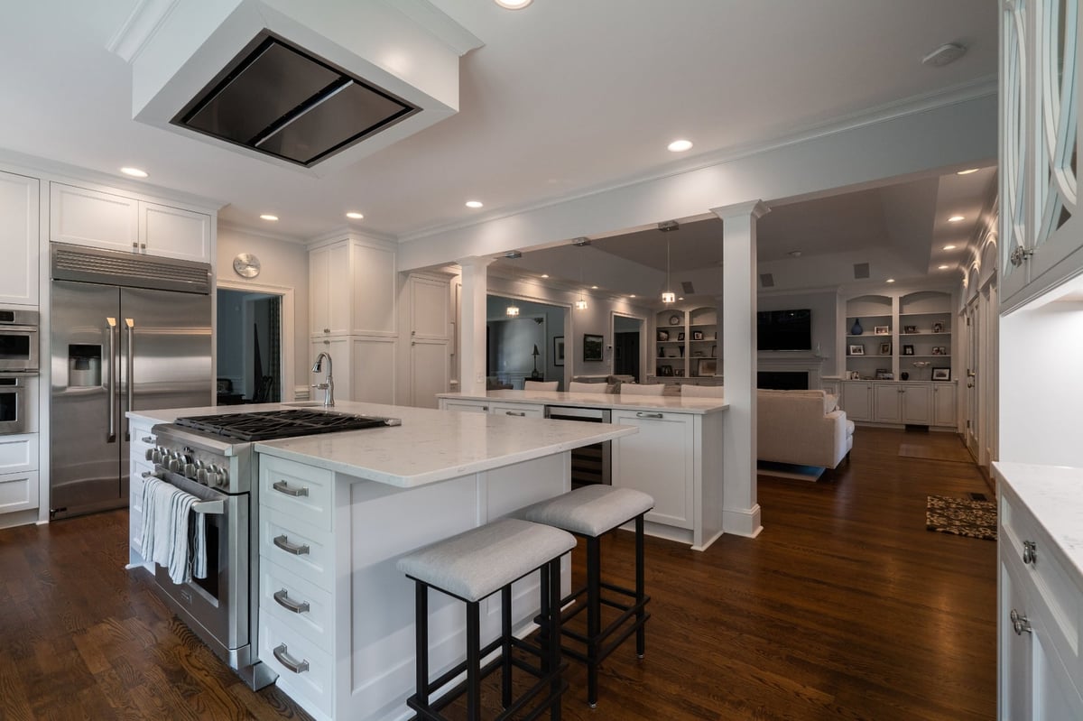 white kitchen island with cooktop and open living area in charlotte nc first floor remodel