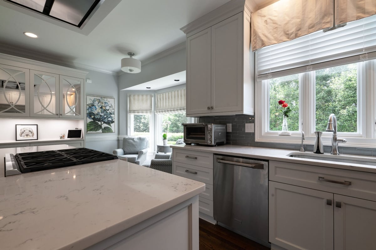 white kitchen island with cooktop and window sink in charlotte nc first floor remodel