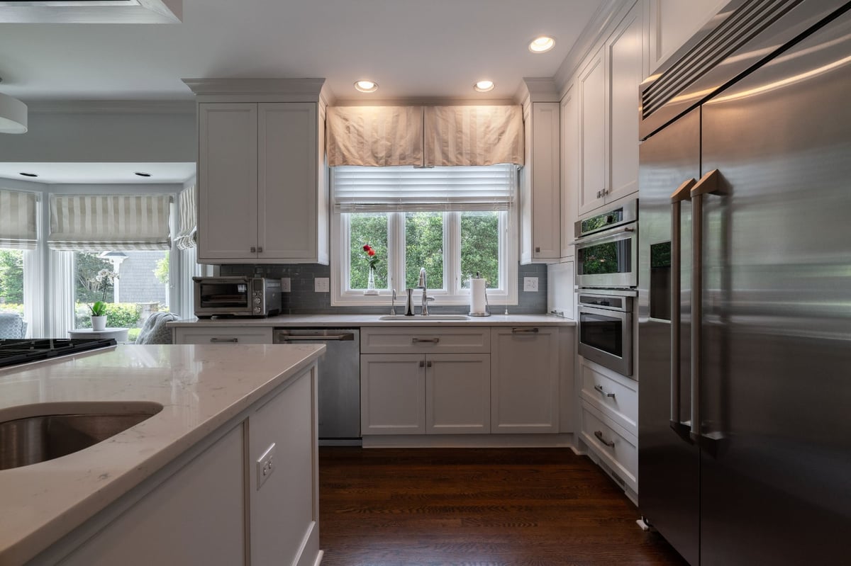 white kitchen with window sink and stainless refrigerator in charlotte nc first floor remodel