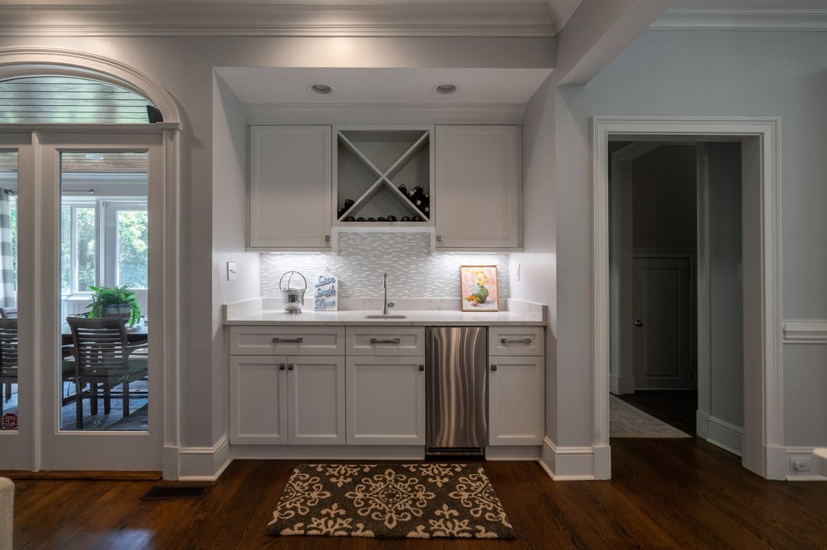 white wet bar cabinetry and beverage cooler in charlotte nc first floor remodel