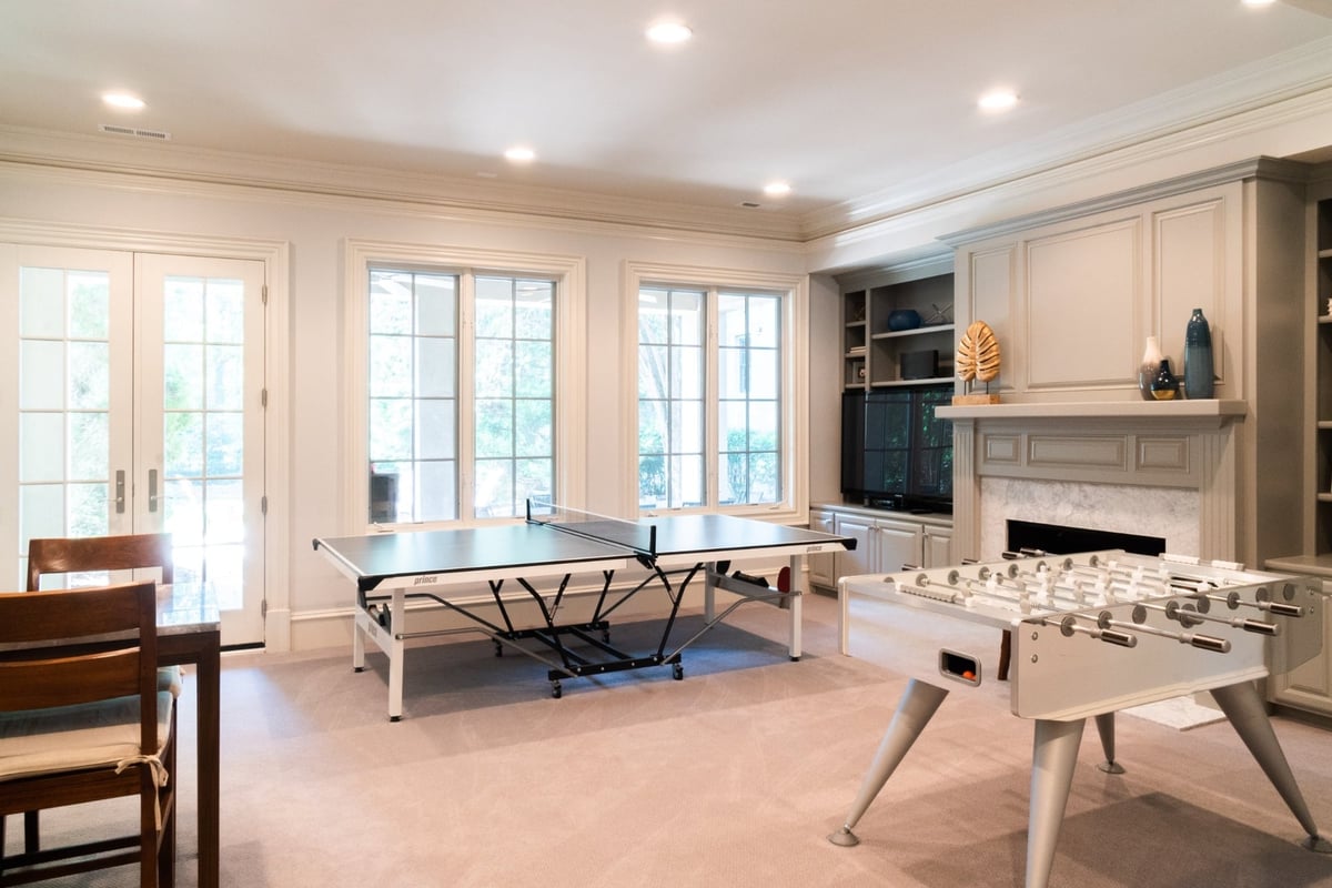 basement recreation room with ping pong foosball and fireplace in charlotte nc whole home remodel