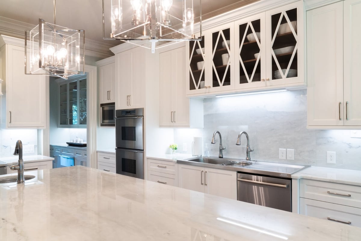 custom white kitchen cabinetry with marble backsplash and double sink in charlotte nc whole home remodel