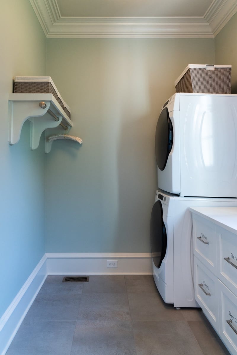 laundry room with stacked washer dryer and custom storage in charlotte nc whole home remodel