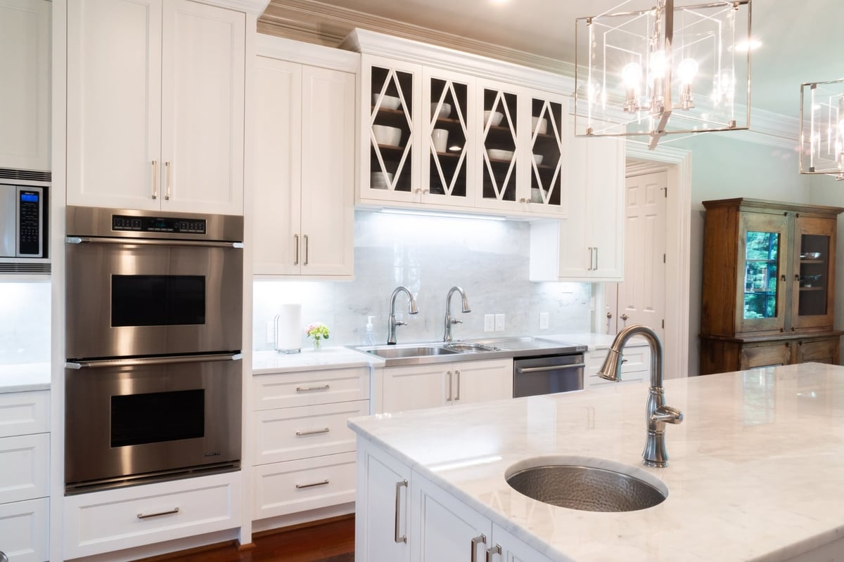 whole home remodel kitchen with double ovens glass front cabinets and island sink in charlotte nc